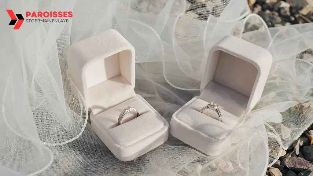 "Can You Get Invited to a Wedding?" A pair of elegant wedding rings in plush velvet boxes, beautifully displayed on delicate white fabric, creating a romantic and timeless atmosphere.