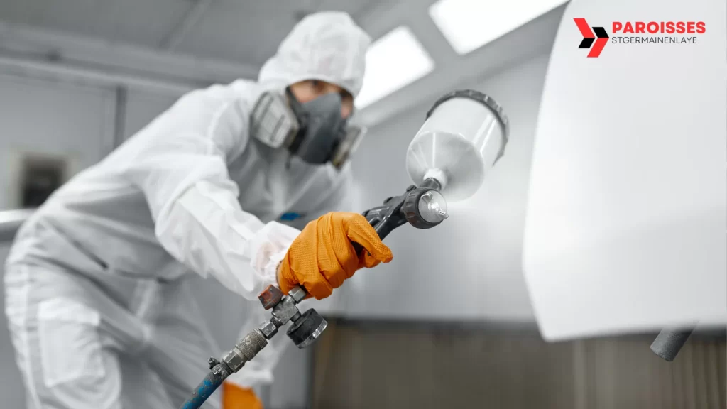 How Long Does Spray Paint Take to Dry by Surface: Professional applying spray paint with protective gear in a controlled environment.