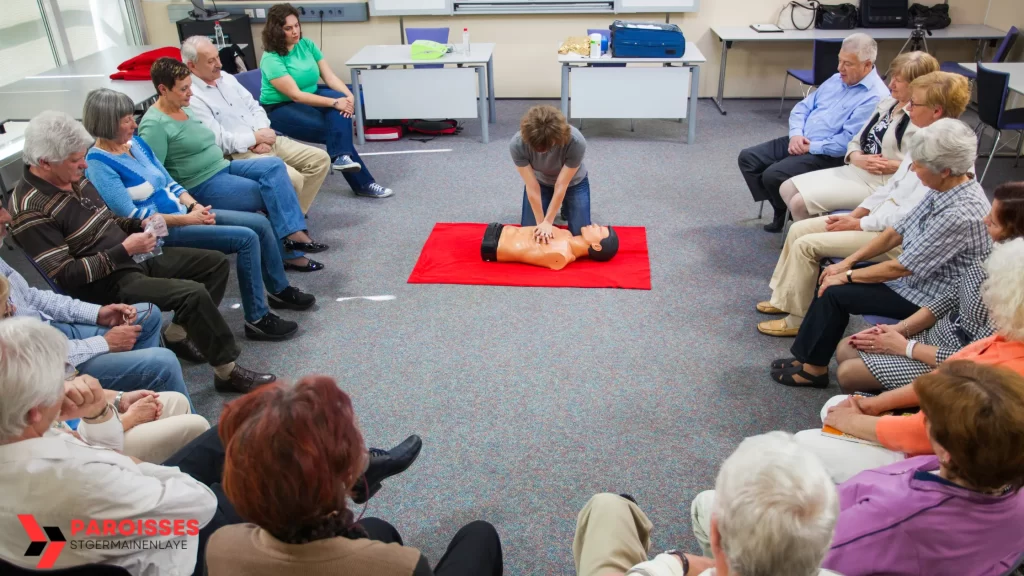 CPR class demonstrating how can you achieve a high chest compression fraction with proper technique on a mannequin in front of a seated audience